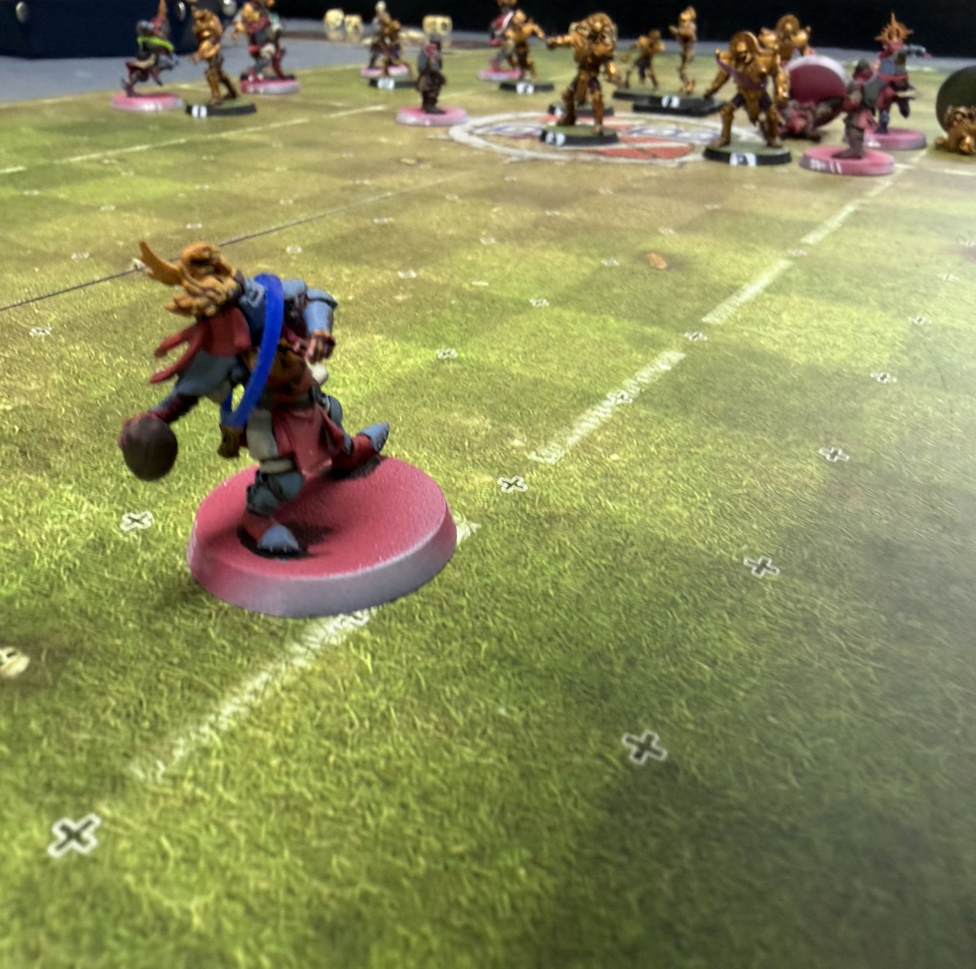 Low-angle shot of a Grenadiers catcher carrying the ball while the Tomb Kings wall holds midfield