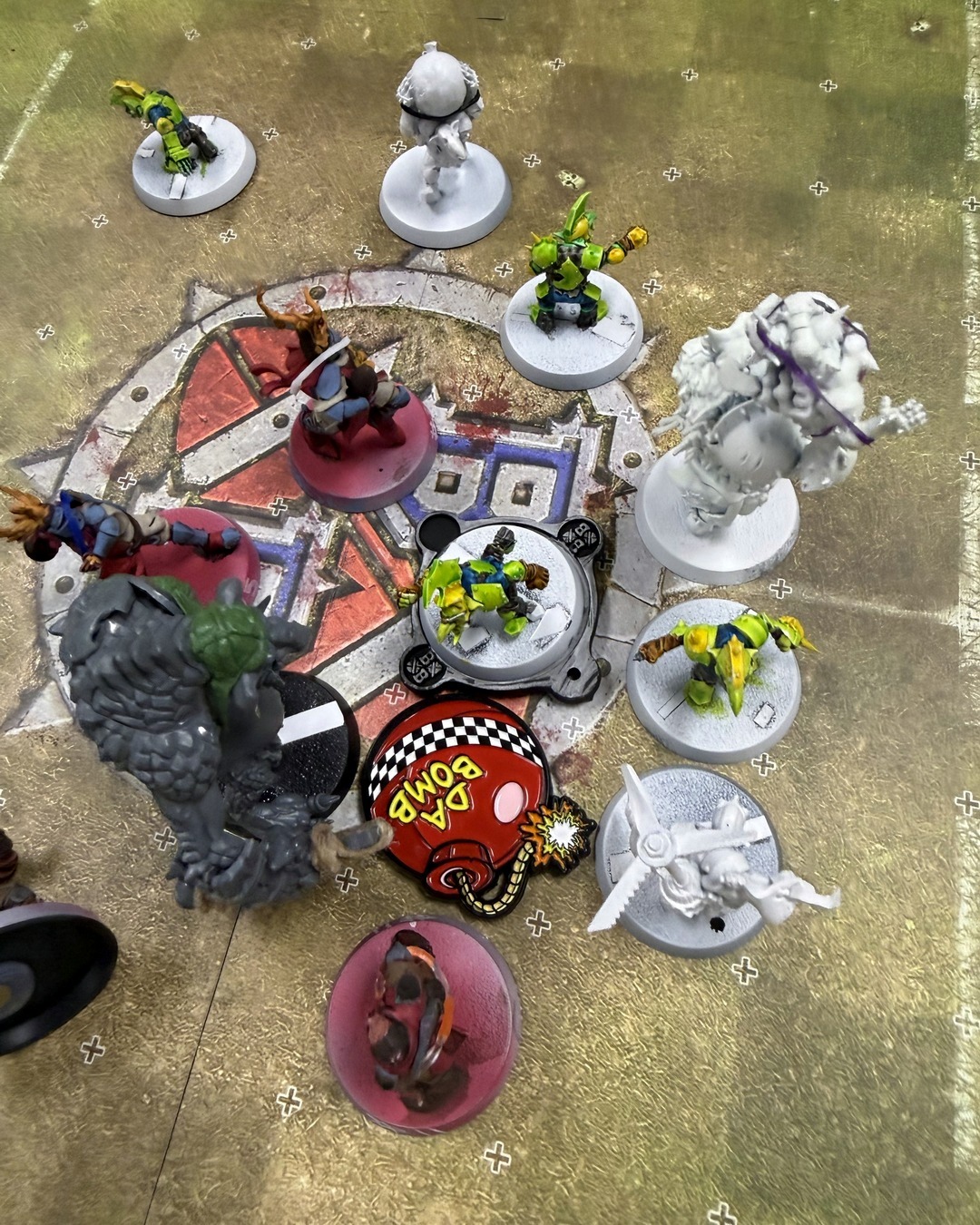 Top-down view of the center of the pitch with the Da Bomb token among goblins and knights