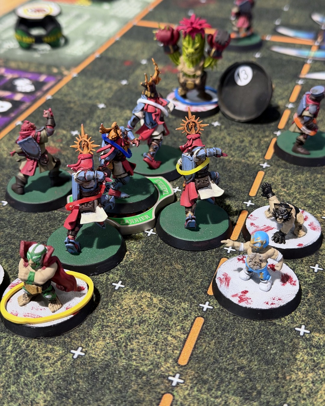 Grenadier knights in a cage pushing upfield, luchador halflings around them