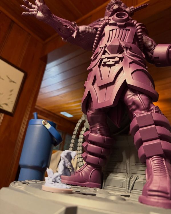 Giant unpainted Galactus towering over the Marvel United board