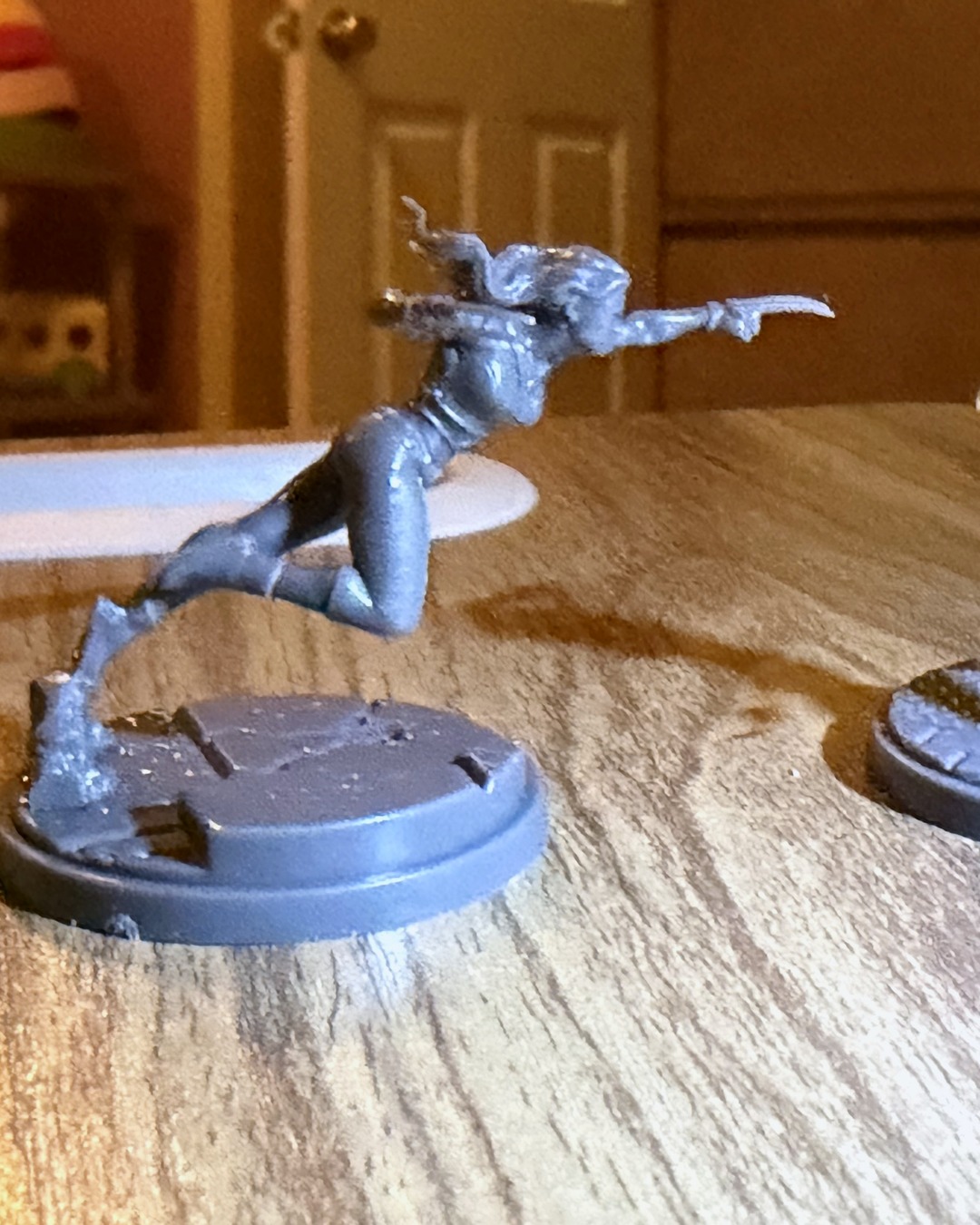 Unpainted X-23 mini leaping forward claws-first from her base