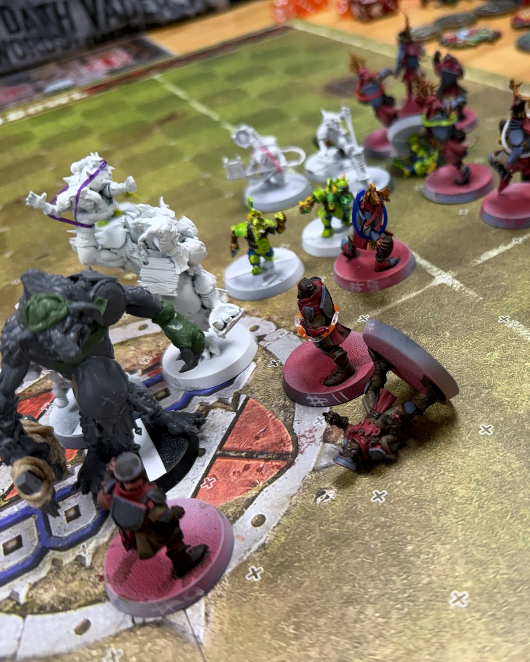 Low-angle view of the scrum with the goblin troll looming on the left