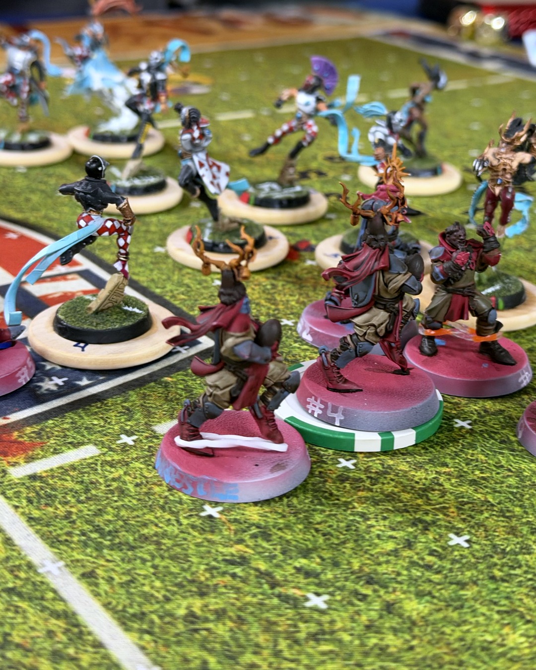 Grenadiers knights in shallow focus squaring up to the Shimmerveil Hurricanes' card-suit High Elves