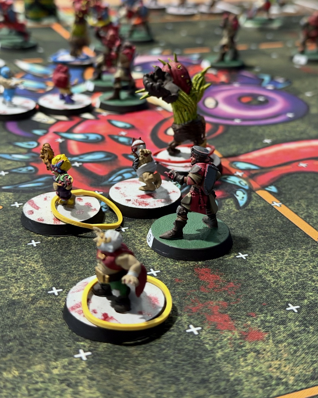 The halflings' Treeman Locustthorn looming over a Grenadier squire, with a caped luchador halfling in front