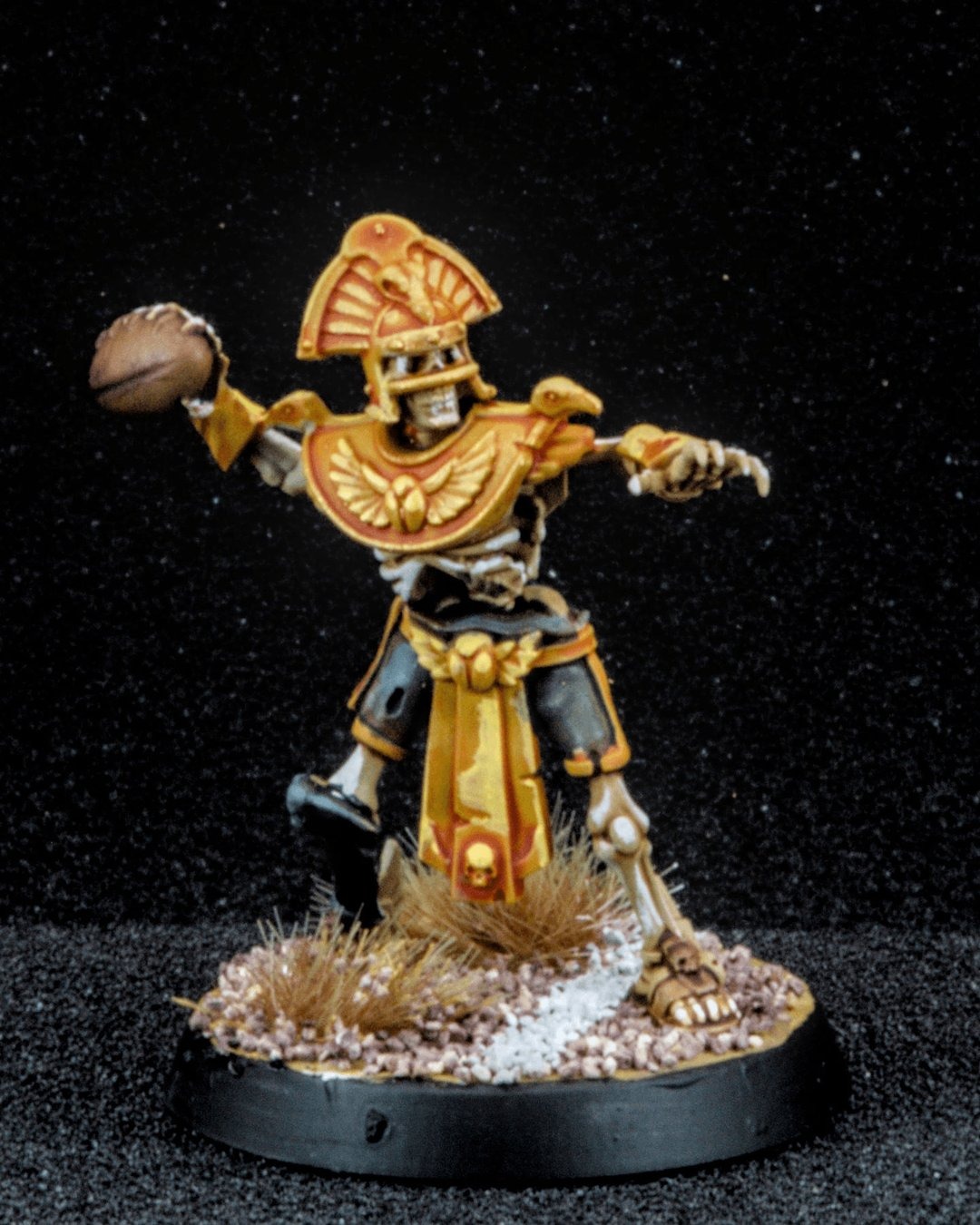 Tomb Kings skeleton thrower in gold, mid-throw