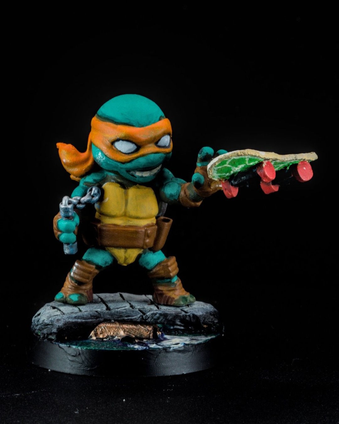 Michelangelo with a pizza and his skateboard