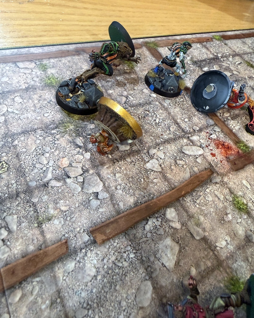 Akhorne's stump tipped over on the pitch next to a downed Werewolf, blood spatter on the turf