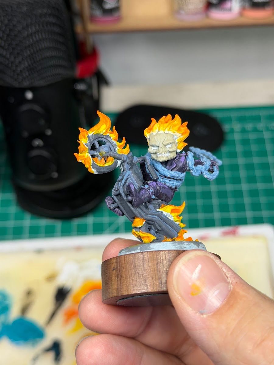 Ghost Rider held in hand mid-paint, flames partly finished
