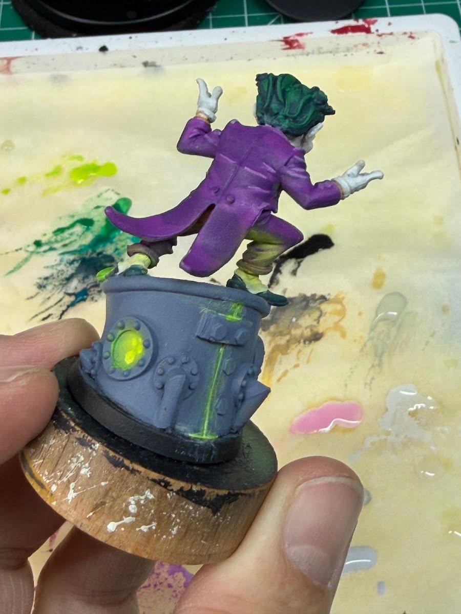 The Joker in progress with green glow creeping up the suit