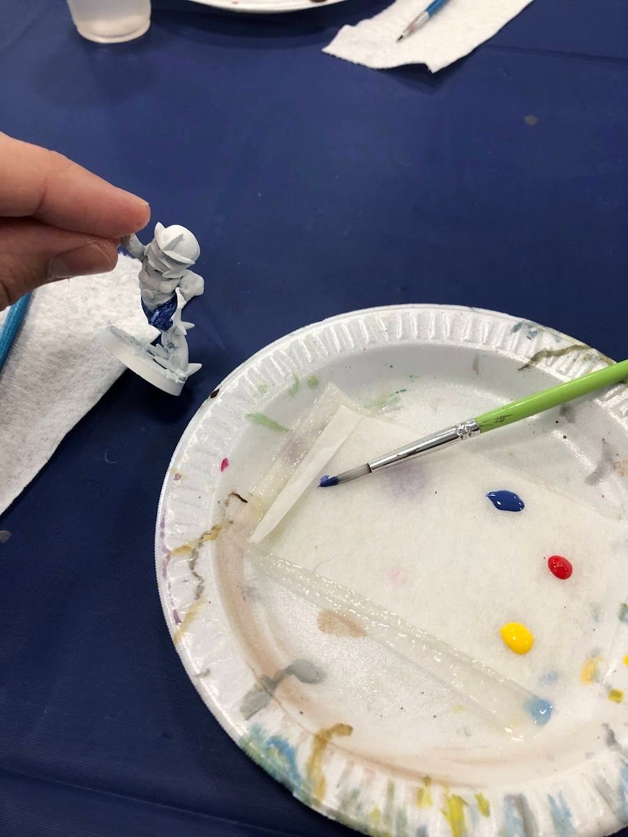 Paper plate palette from the paint-and-take with a few dots of color