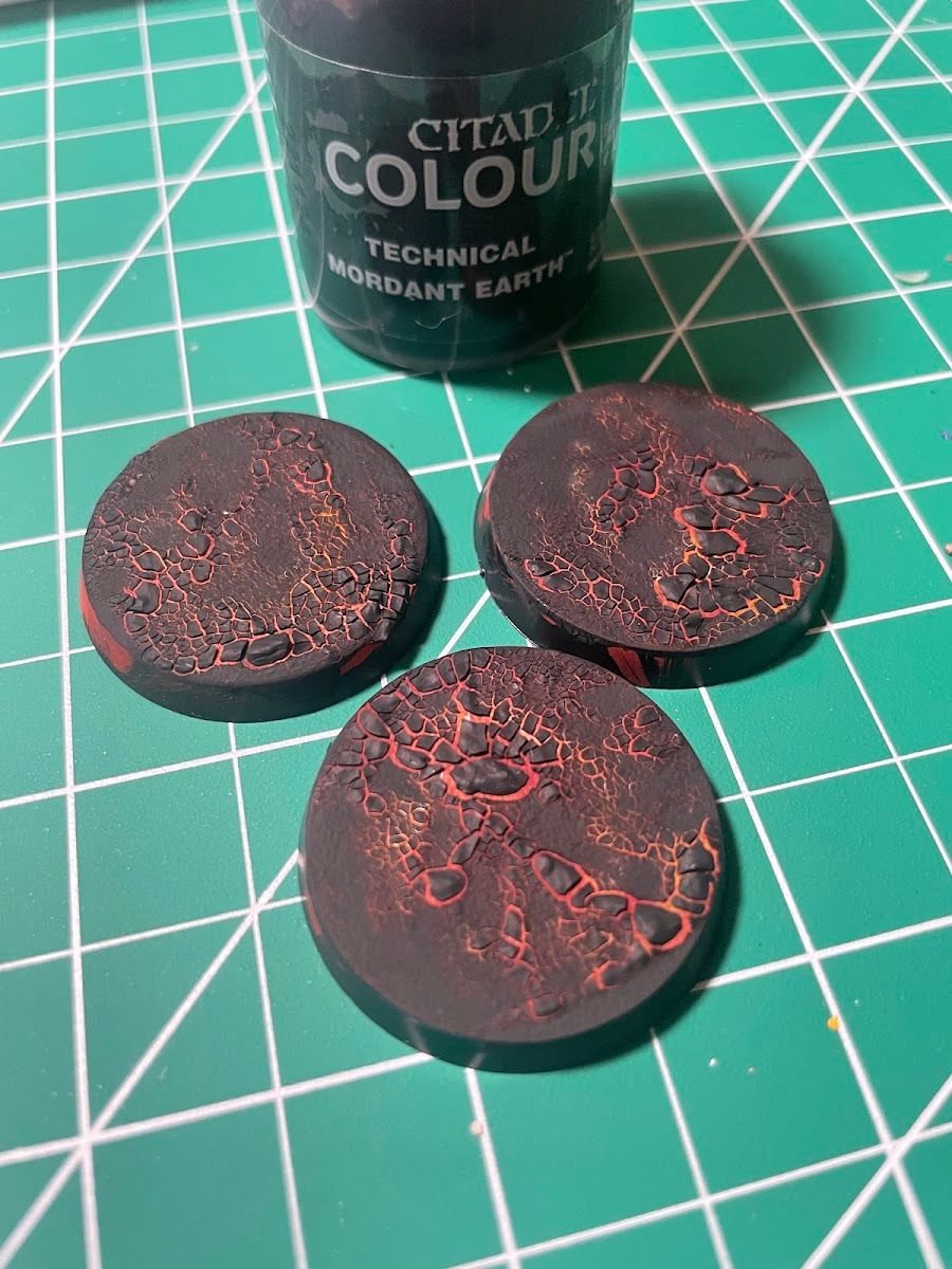 Round bases with textured crackle paint and a Citadel technical paint pot